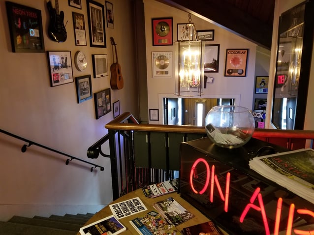 Rock memorabilia covers the CD 102.5 office walls