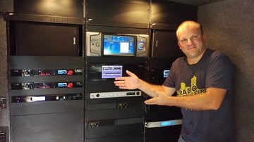 Dave Collins displays the Wall of Omnia in the Telos Alliance van