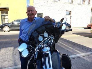 Saul Levine poses with a Harley